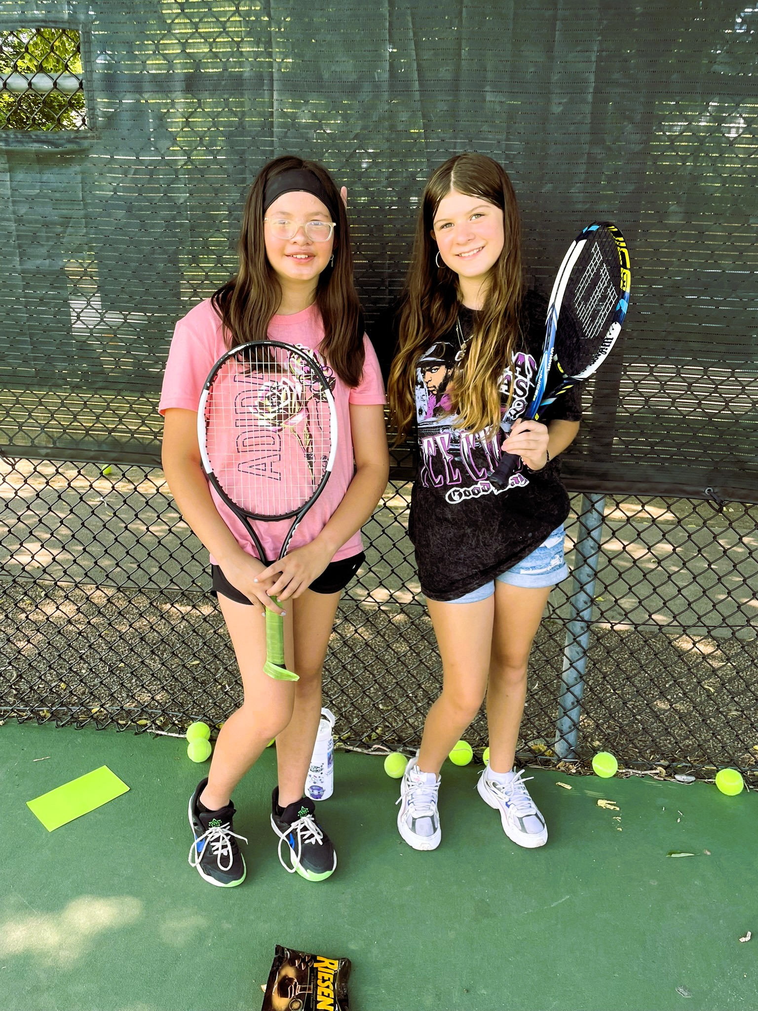 Two students holding tennis racket